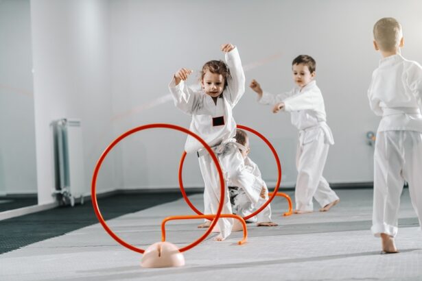 Small group of Caucasian kids in doboks practicing taekwondo and warming up for treining while standing barefoot.